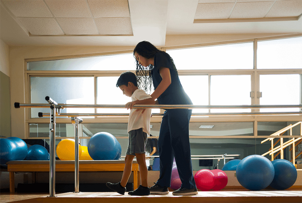 Pediatric Physical Therapy Services - A Physical Therapist performing Physical Therapy on a boy